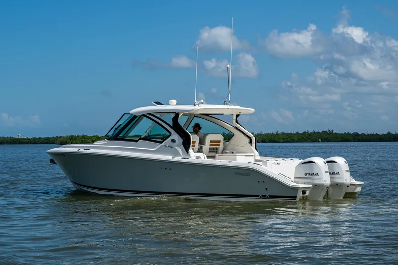  Yacht Photos Pics 2021 Pursuit DC 326 Dual Console boat cruising on a sunny day.