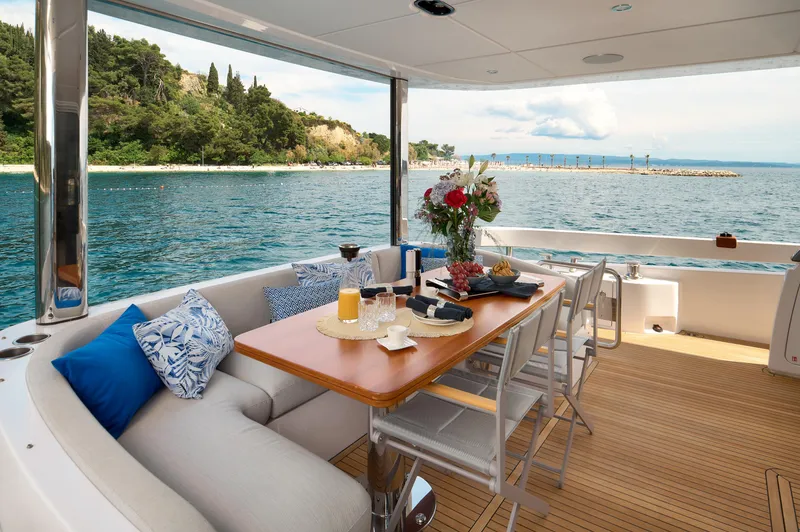  Yacht Photos Pics Luxury Azimut 78 yacht deck with dining setup, ocean view, and elegant seating, 2022 model.