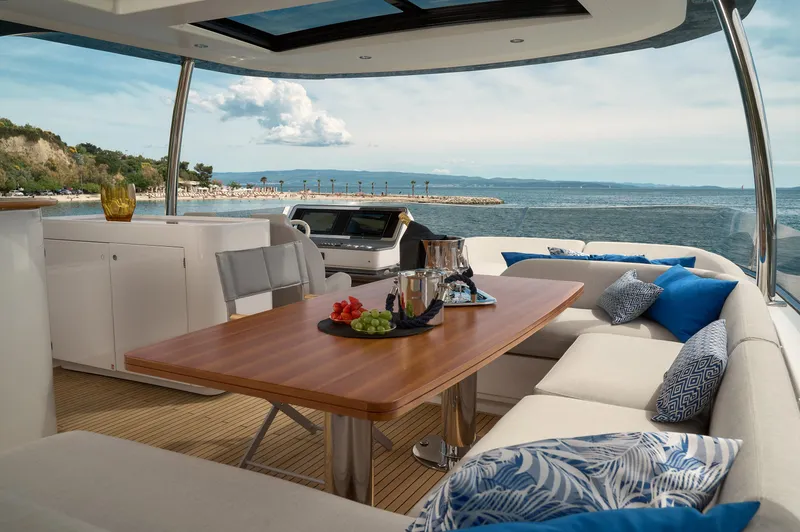  Yacht Photos Pics Luxurious 2022 Azimut 78 yacht interior with ocean view, featuring elegant seating and dining area.