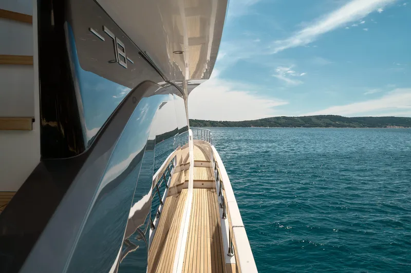  Yacht Photos Pics Azimut 78 yacht cruising on open sea, 2022 model, with sleek design and wooden deck.