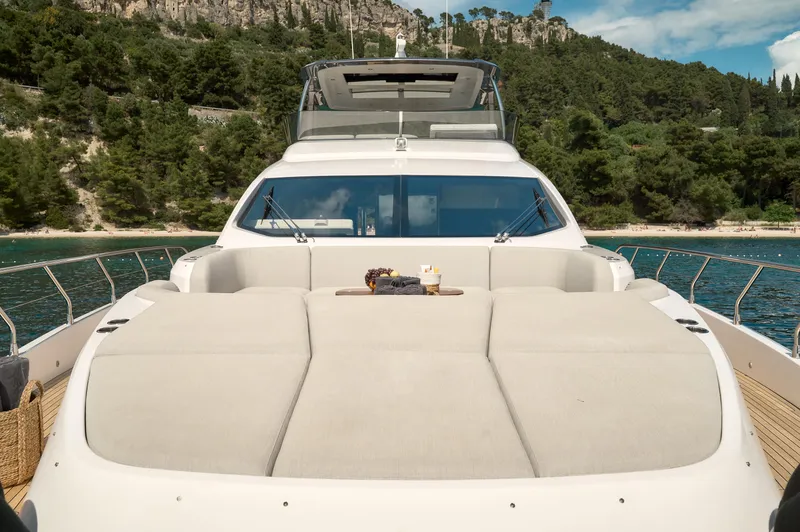  Yacht Photos Pics Luxurious 2022 Azimut 78 yacht with spacious sunbathing deck, cruising on serene waters.