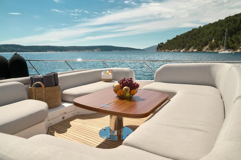  Yacht Photos Pics Luxurious Azimut 78 yacht deck with elegant seating, table, and ocean view, 2022 model.