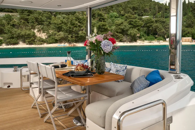  Yacht Photos Pics Luxurious Azimut 78 yacht deck with dining area, elegant seating, and ocean view, 2022 model.