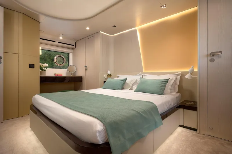  Yacht Photos Pics Luxurious bedroom interior of 2022 Azimut 78 yacht with modern design and ambient lighting.