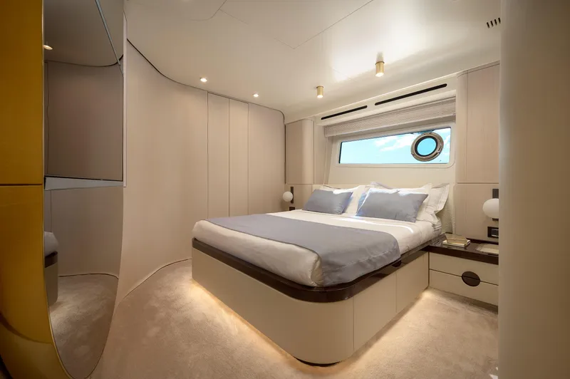  Yacht Photos Pics Luxurious bedroom interior of 2022 Azimut 78 yacht with modern design and elegant furnishings.