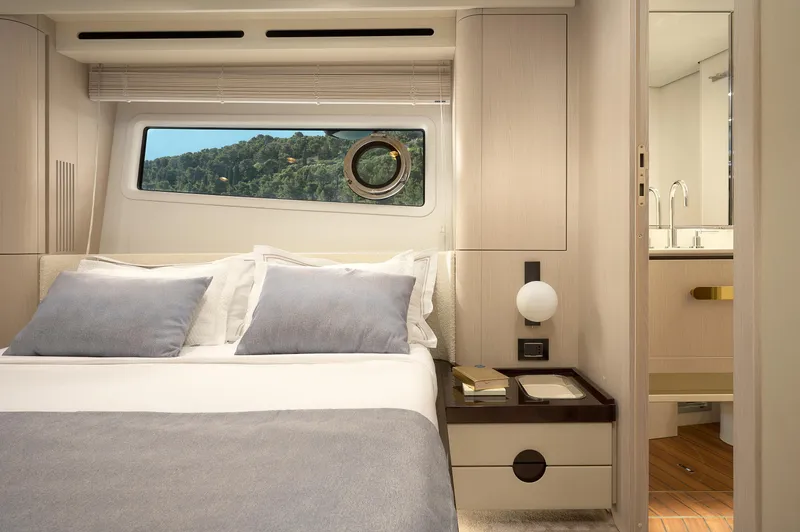 Yacht Photos Pics Luxurious bedroom interior of 2022 Azimut 78 yacht with scenic window view.