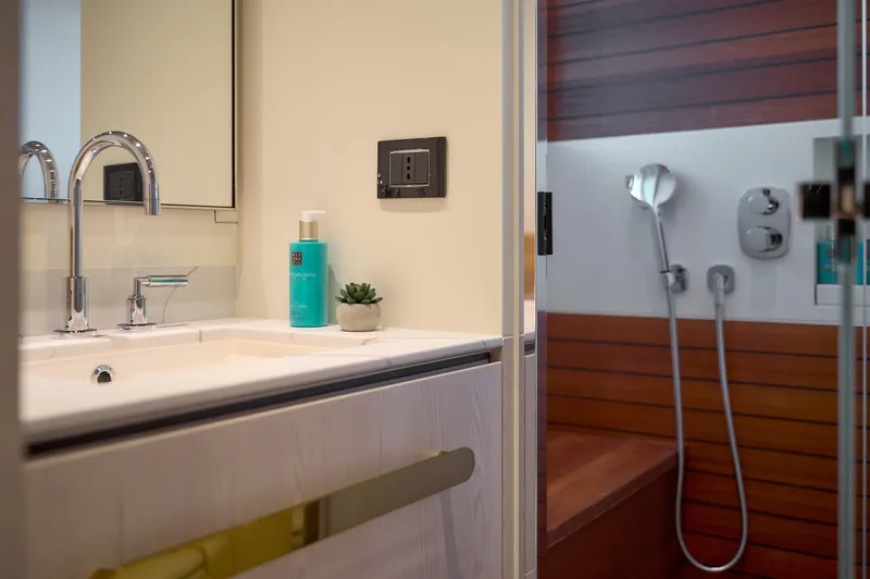  Yacht Photos Pics Luxurious bathroom in 2022 Azimut 78 yacht, featuring modern sink and shower design.