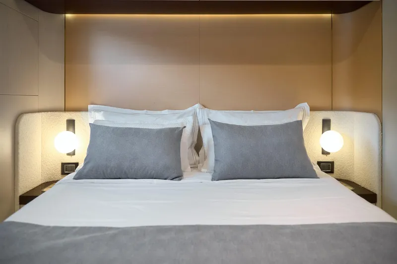  Yacht Photos Pics Luxurious bedroom interior on 2022 Azimut 78 yacht with elegant bedding and ambient lighting.