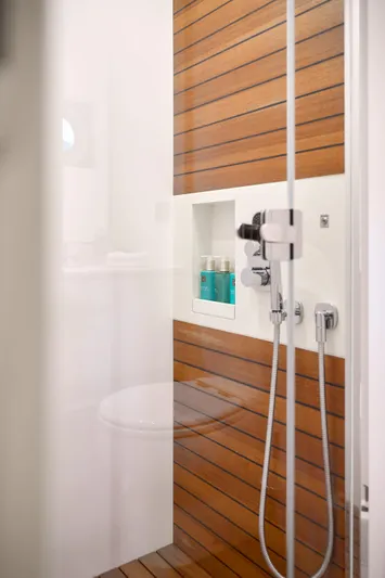  Yacht Photos Pics Shower area in 2022 Azimut 78 yacht with wood paneling and modern fixtures.