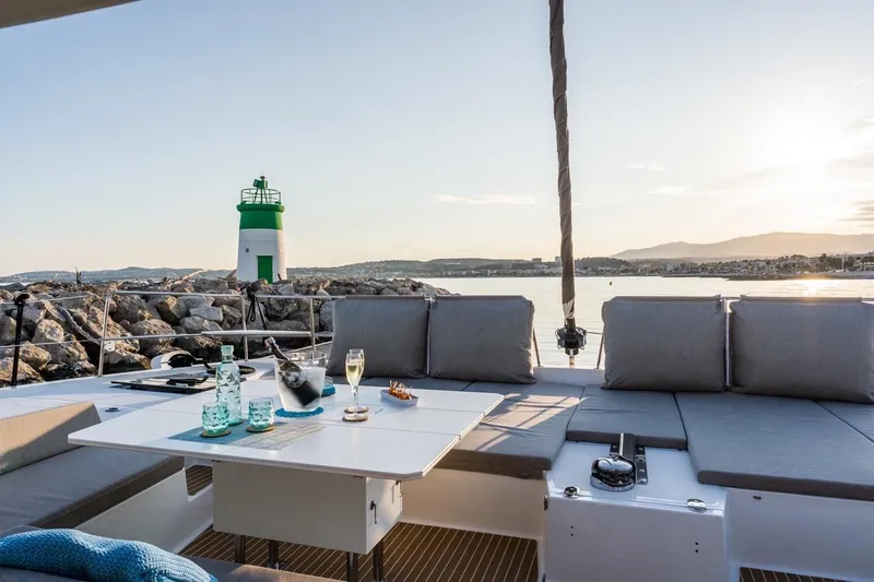 Signature Bali 5.4. (6+ 2 Cabins) Yacht Photos Pics Luxurious Bali 5.4 yacht deck with drinks, lighthouse view, and sunset in 2022.