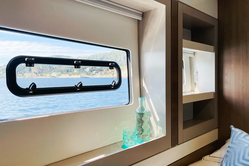 Signature Bali 5.4. (6+ 2 Cabins) Yacht Photos Pics Interior view of Bali 5.4 yacht cabin with ocean view through window, 2022 model.