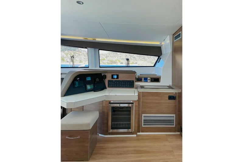 Signature Bali 5.4. (6+ 2 Cabins) Yacht Photos Pics Modern interior of 2022 Bali 5.4 yacht with navigation controls and wooden cabinetry.