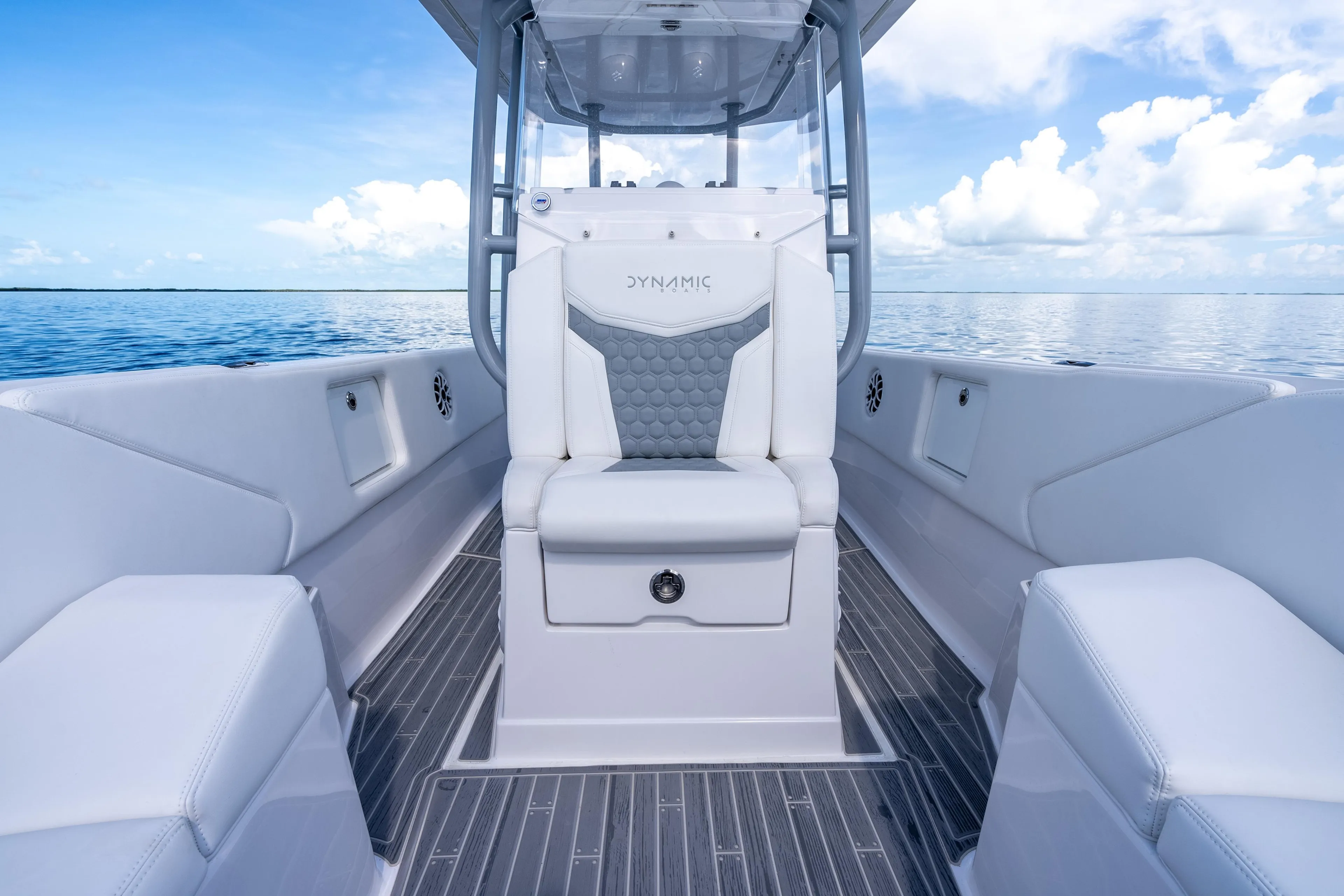 Luxury interior of 2023 Dynamic D-305V boat with sleek seating and ocean view.