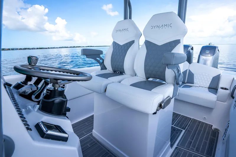  Yacht Photos Pics 2023 Dynamic D-305V boat interior with modern steering and seating on calm water.