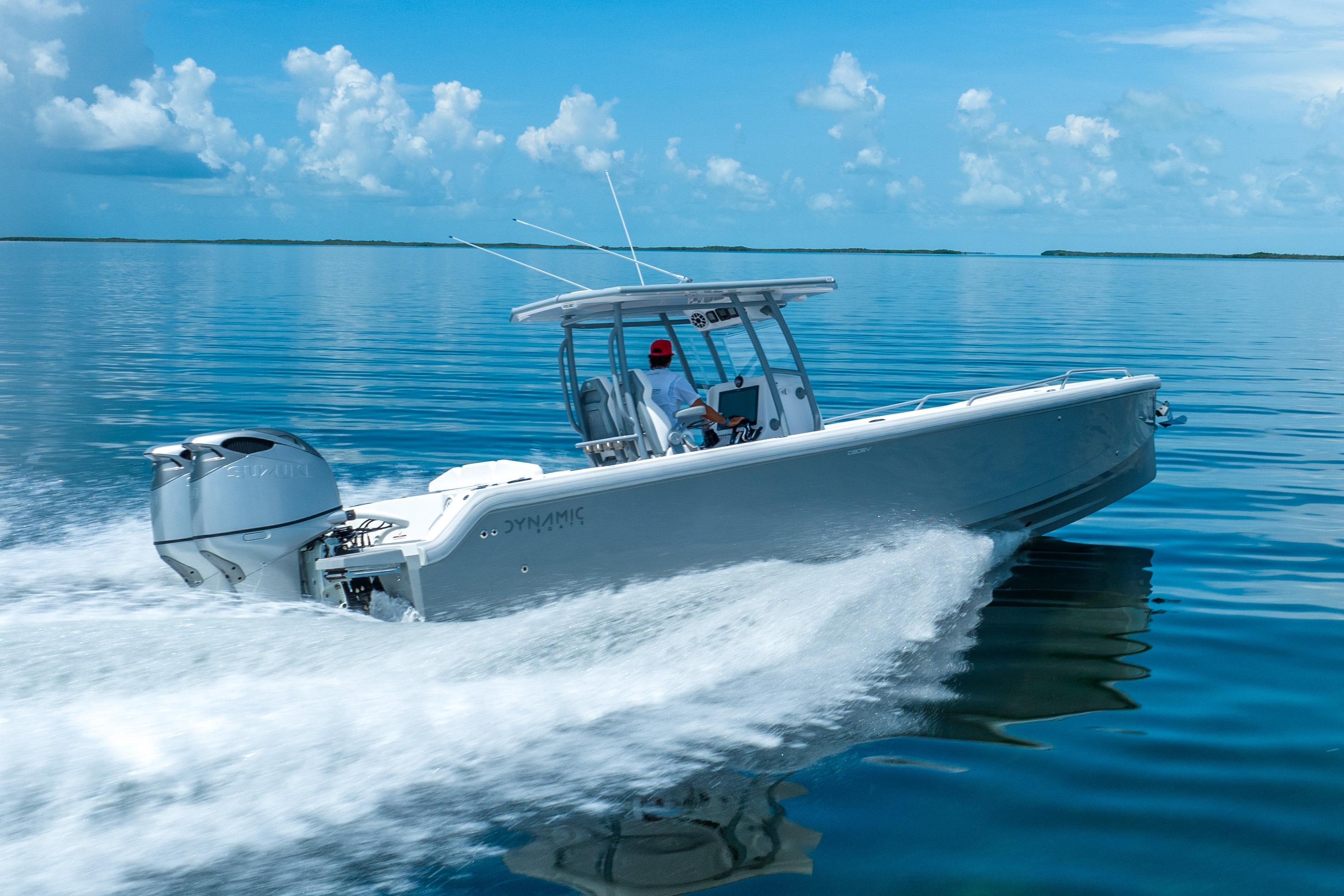 2023 Dynamic D-305V boat cruising on calm blue waters under a clear sky.