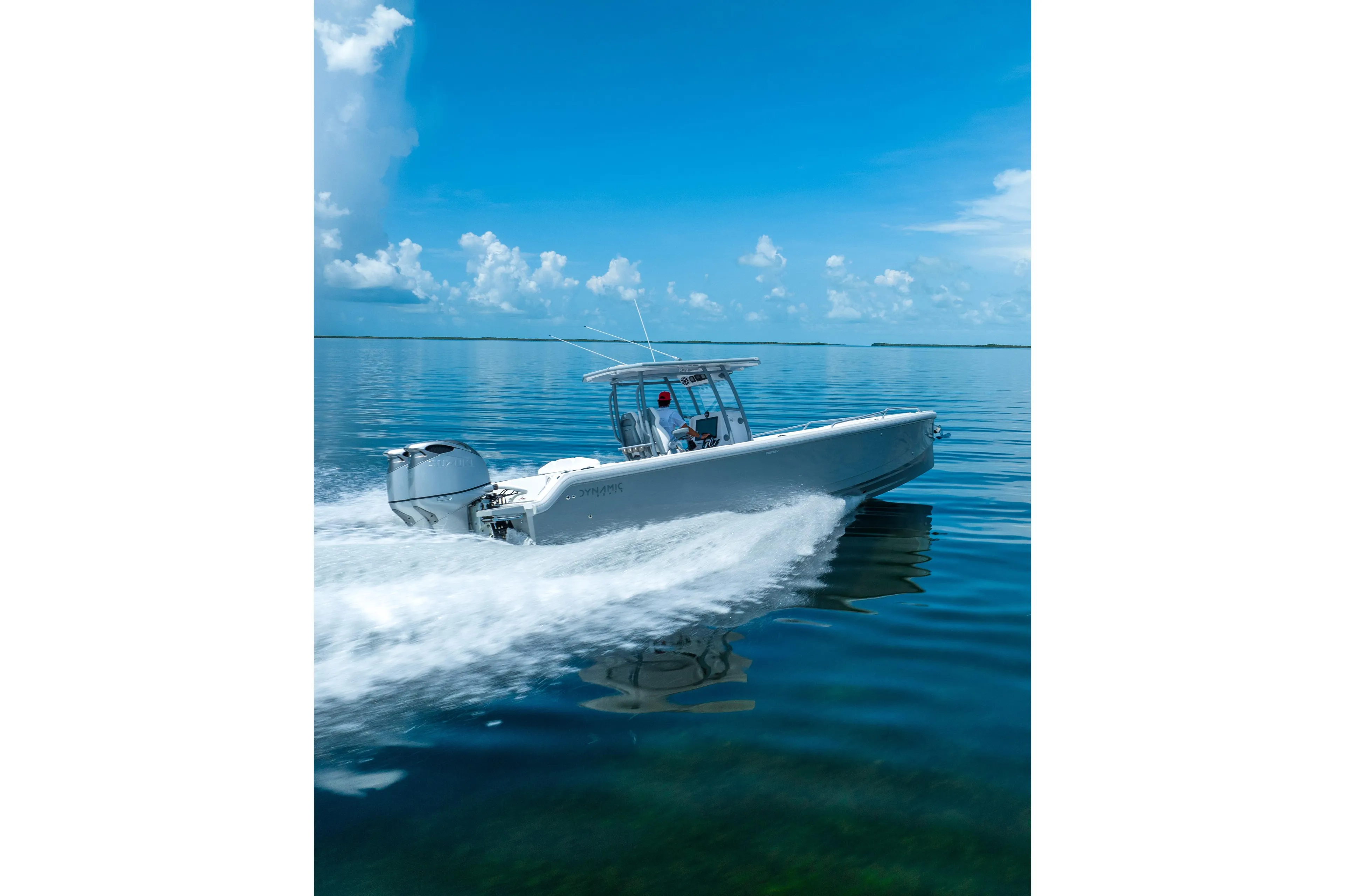 Dynamic D-305V 2023 boat cruising on calm blue waters under a clear sky.