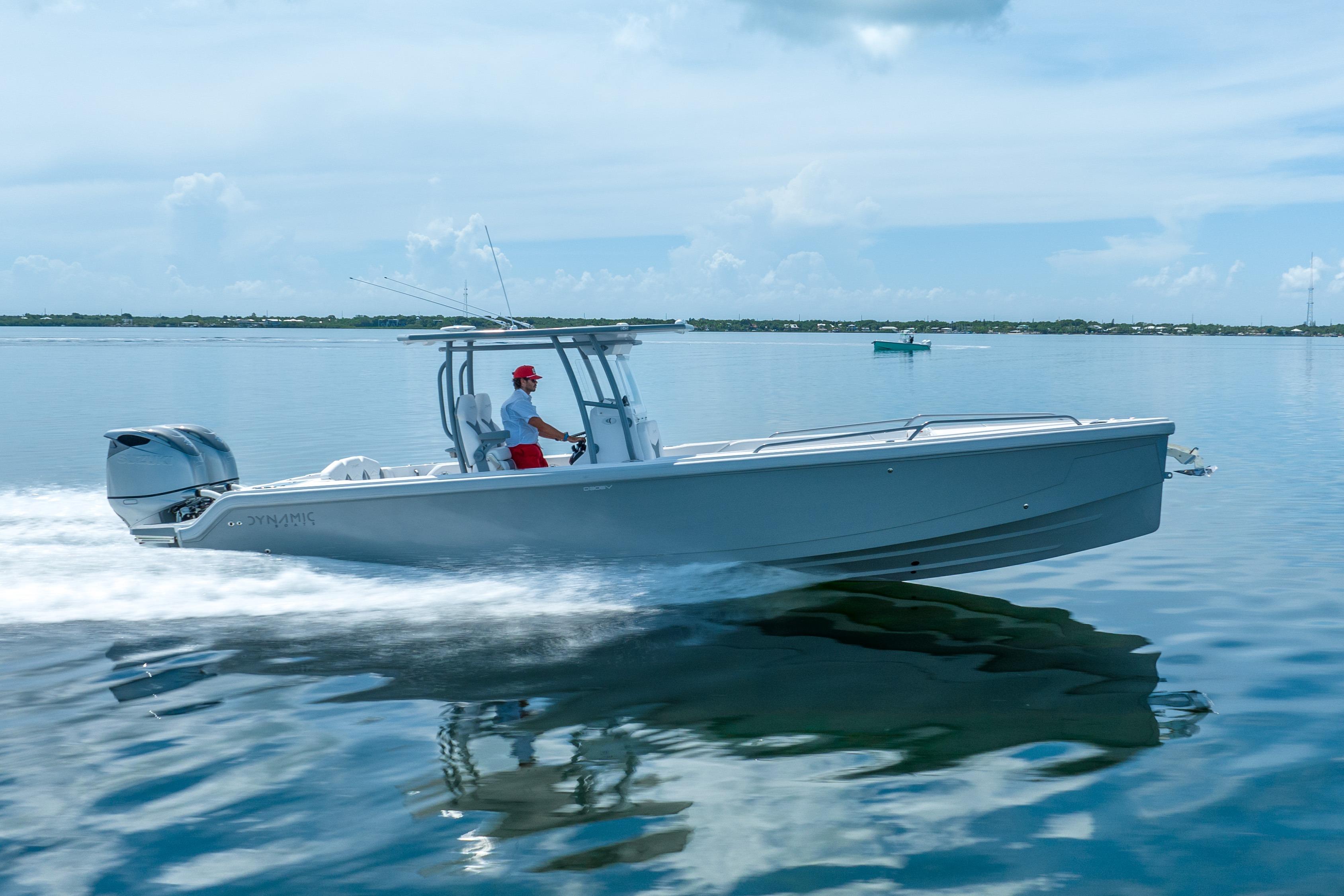 2023 Dynamic D-305V boat cruising on calm water under a clear sky.