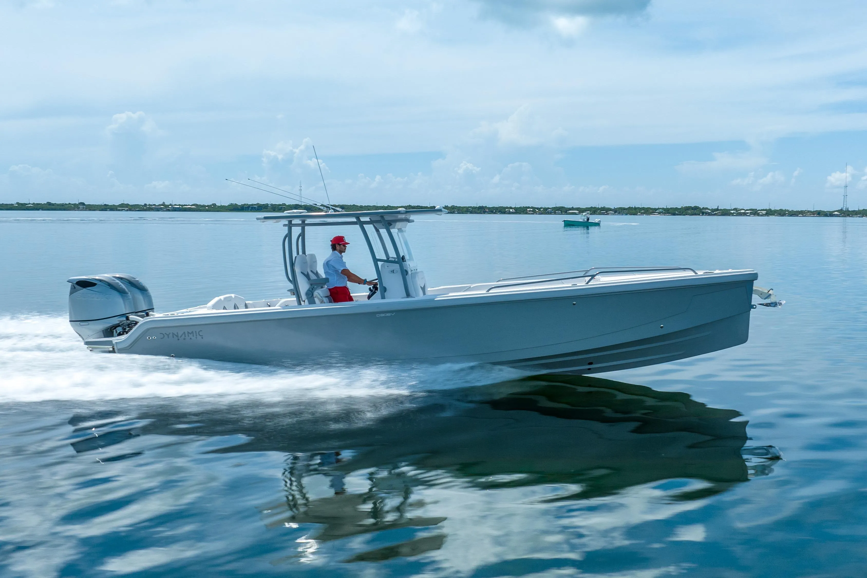 2023 Dynamic D-305V boat cruising on calm water under a clear sky.