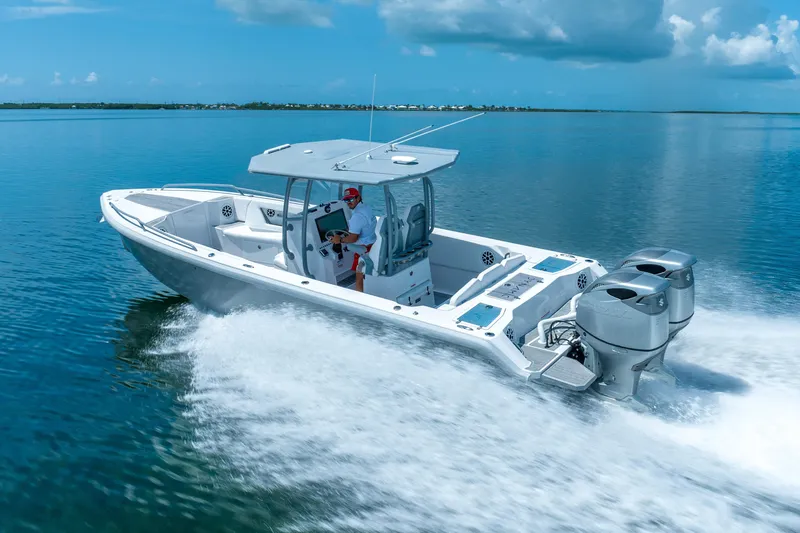  Yacht Photos Pics 2023 Dynamic D-305V boat cruising on clear blue water under a sunny sky.