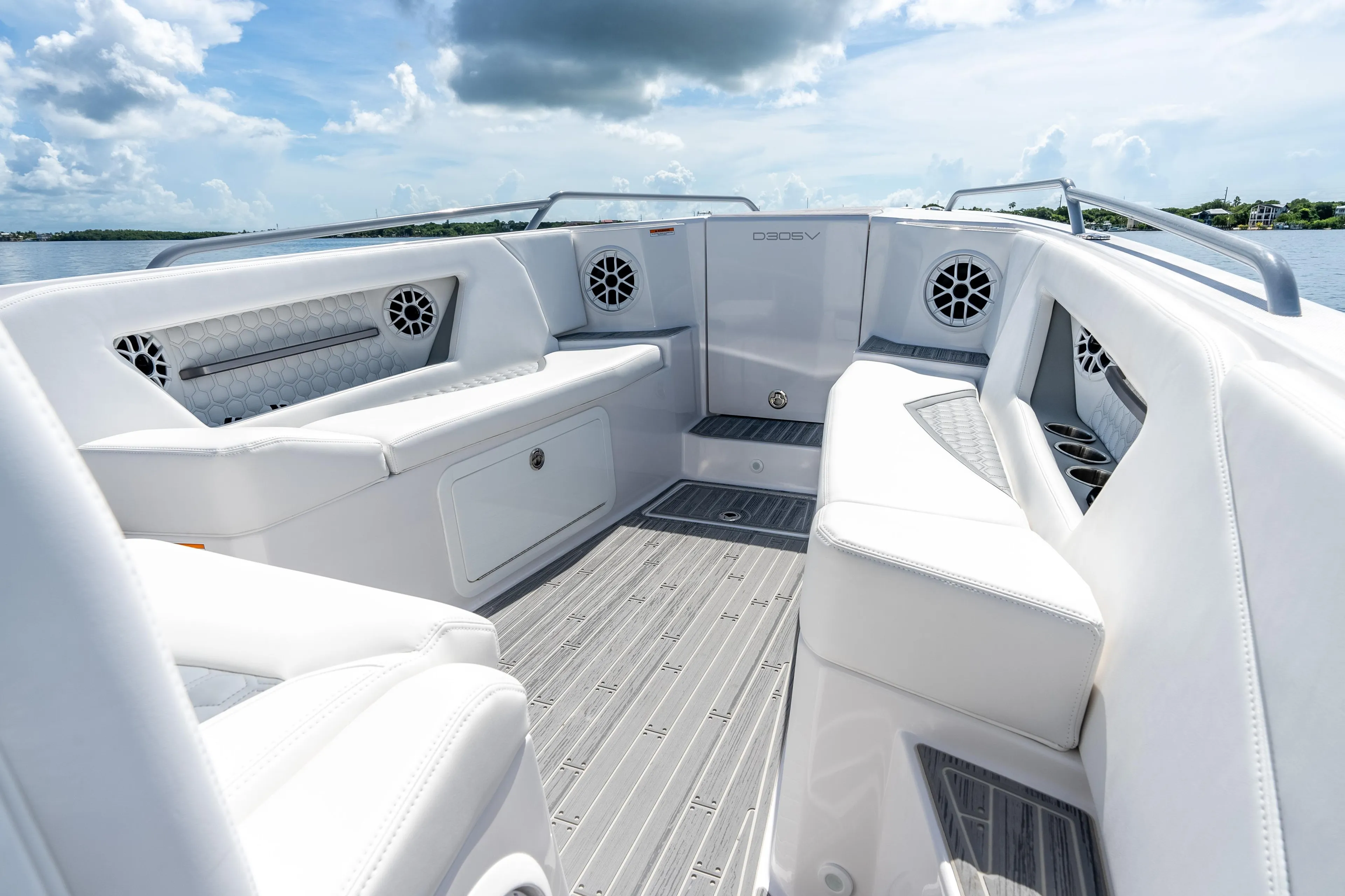 Luxurious interior of 2023 Dynamic D-305V boat with white seating and modern design.