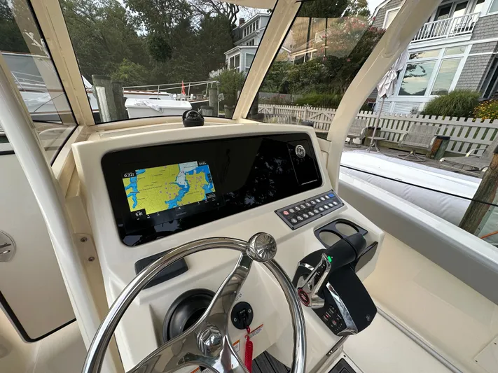 Yacht Photos Pics Interior view of 2024 Scout 277 LXF boat cockpit with navigation system.