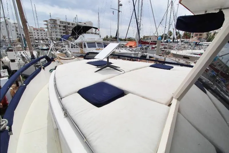  Yacht Photos Pics 1989 Grand Banks Classic yacht with cushioned deck, docked in a marina.