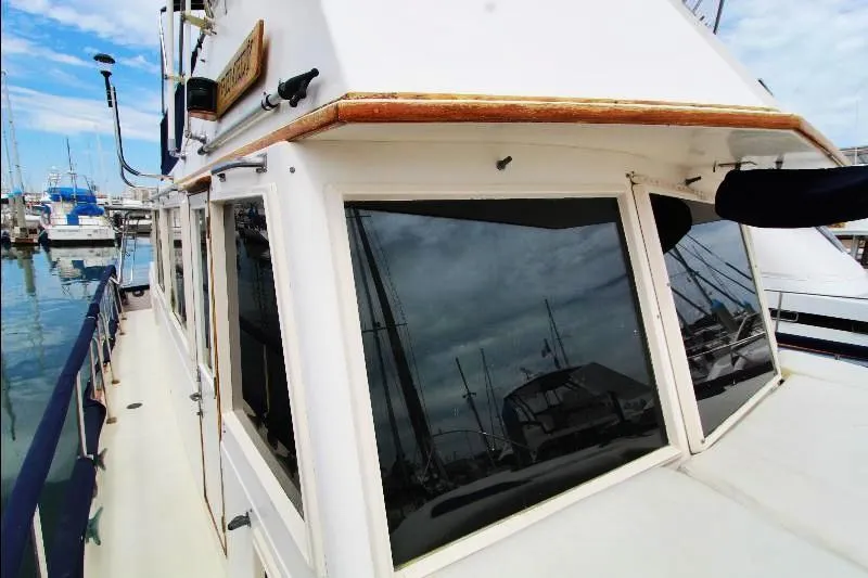  Yacht Photos Pics 1989 Grand Banks Classic yacht docked at marina, showcasing cabin windows and nautical design.