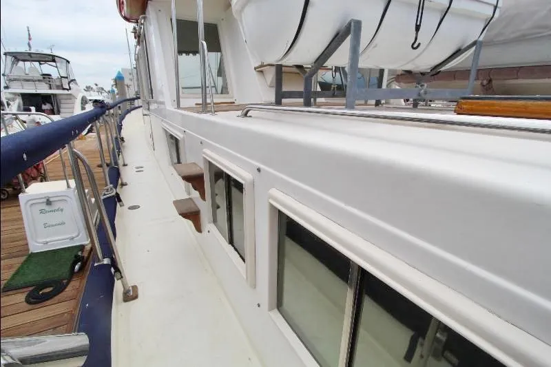  Yacht Photos Pics 1989 Grand Banks Classic yacht docked, showcasing side deck and windows.