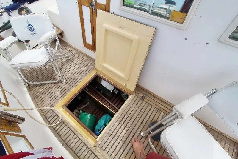  Yacht Photos Pics Open hatch on 1989 Grand Banks Classic boat deck with chairs and storage view.