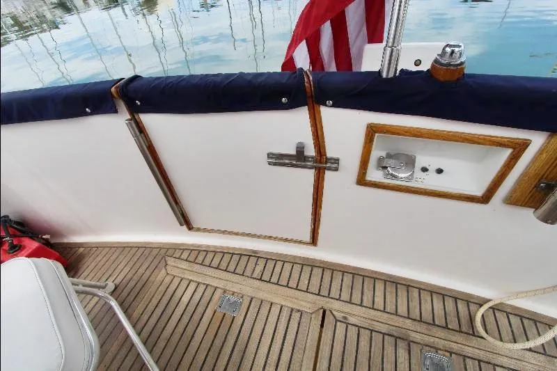  Yacht Photos Pics 1989 Grand Banks Classic boat deck with wooden flooring and American flag.