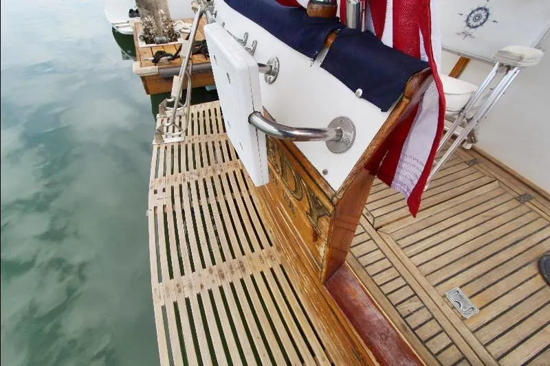  Yacht Photos Pics 1989 Grand Banks Classic yacht with wooden deck and American flag at marina.