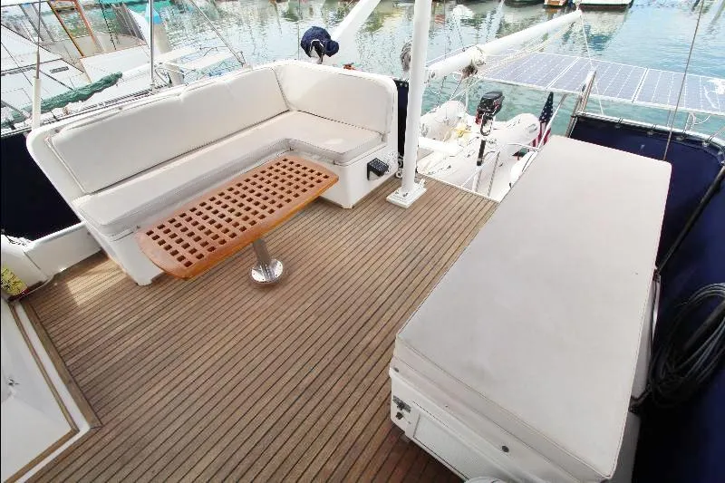 Yacht Photos Pics 1989 Grand Banks Classic yacht deck with cushioned seating and wooden table.