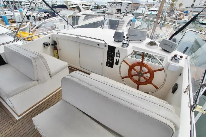  Yacht Photos Pics 1989 Grand Banks Classic yacht helm with wooden wheel and white seating.
