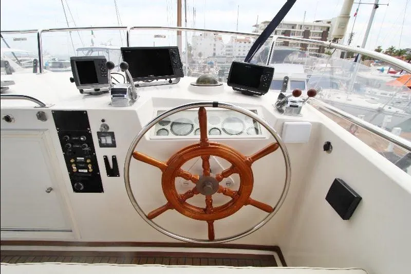  Yacht Photos Pics 1989 Grand Banks Classic yacht helm with wooden wheel and navigation equipment.