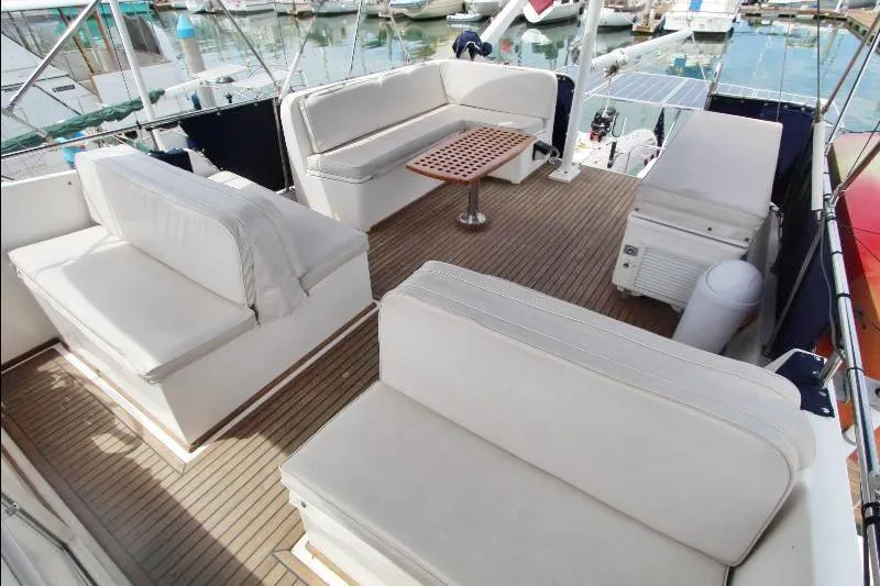  Yacht Photos Pics 1989 Grand Banks Classic yacht deck with cushioned seating and wooden table.