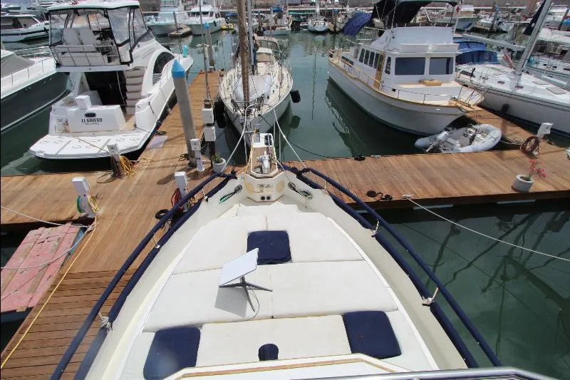  Yacht Photos Pics 1989 Grand Banks Classic yacht docked in a marina, surrounded by other boats.