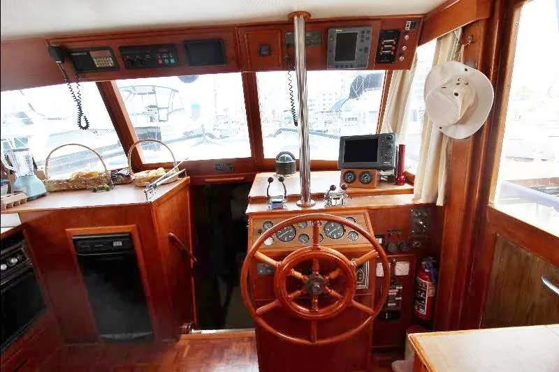  Yacht Photos Pics 1989 Grand Banks Classic yacht interior with wooden helm, navigation equipment, and nautical decor.