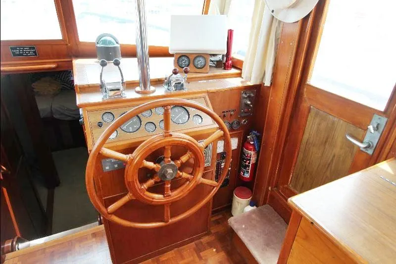  Yacht Photos Pics 1989 Grand Banks Classic helm with wooden wheel and navigation instruments.