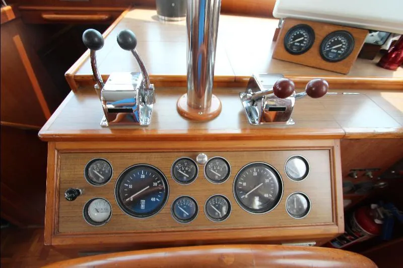  Yacht Photos Pics Control panel of a 1989 Grand Banks Classic boat with gauges and levers.