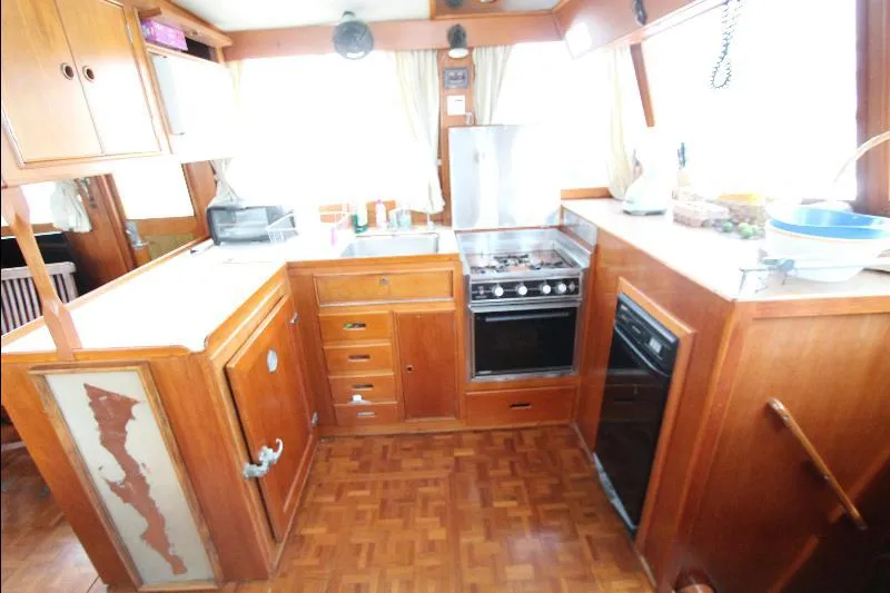  Yacht Photos Pics 1989 Grand Banks Classic yacht kitchen with wooden cabinetry and modern appliances.