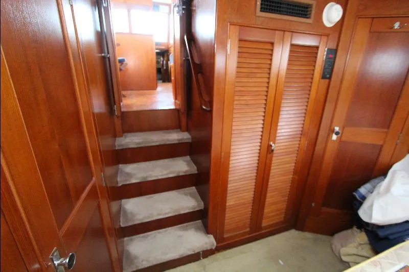  Yacht Photos Pics Interior of 1989 Grand Banks Classic yacht with wooden paneling and carpeted stairs.