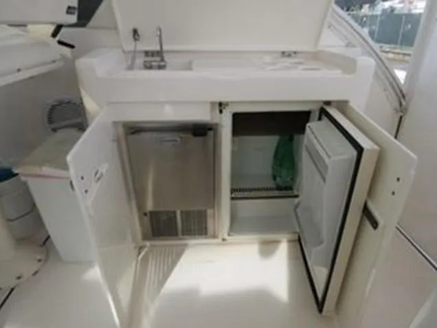 Shelly Anne Yacht Photos Pics 2000 Tiara Yachts 5200 Express interior with open cabinets and sink.