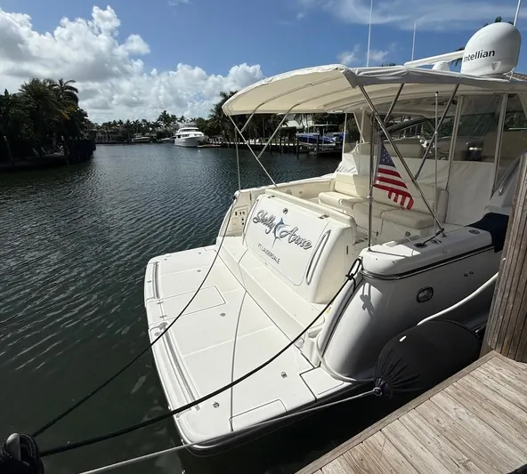 Shelly Anne Yacht Photos Pics 2000 Tiara Yachts 5200 Express docked in a serene marina setting.