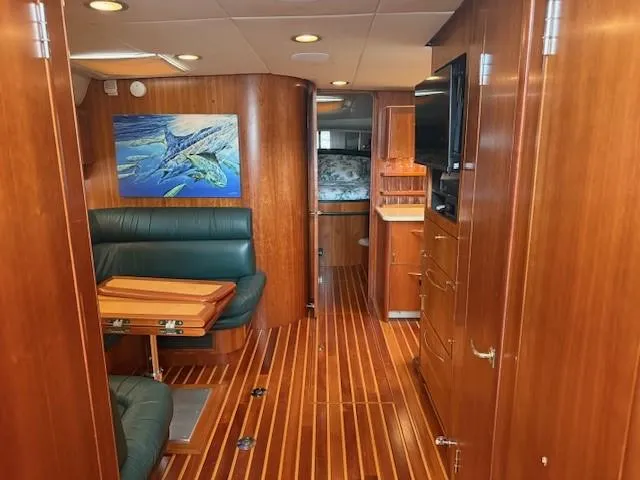 Shelly Anne Yacht Photos Pics Interior of 2000 Tiara Yachts 5200 Express with wood paneling and seating area.