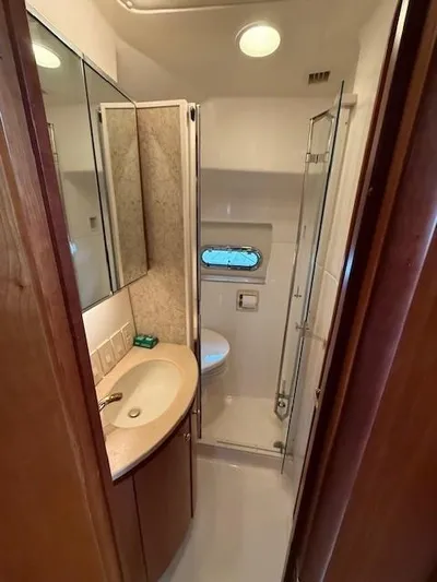 Shelly Anne Yacht Photos Pics Bathroom interior of 2000 Tiara Yachts 5200 Express with sink, toilet, and shower.