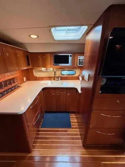 Shelly Anne Yacht Photos Pics Interior of 2000 Tiara Yachts 5200 Express, featuring a modern kitchen with wood cabinetry.