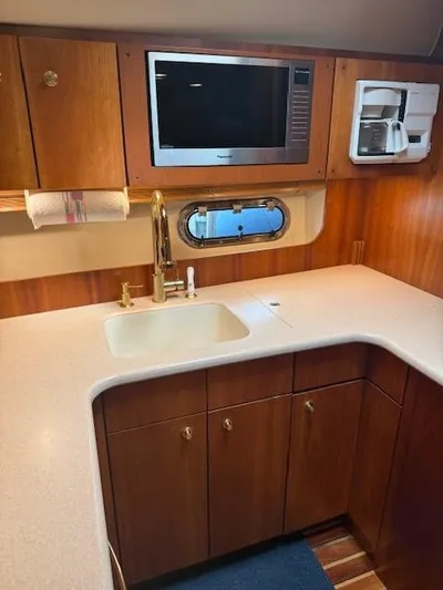 Shelly Anne Yacht Photos Pics 2000 Tiara Yachts 5200 Express kitchen with sink, microwave, and coffee maker.