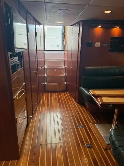 Shelly Anne Yacht Photos Pics Interior of 2000 Tiara Yachts 5200 Express with wood flooring and seating area.