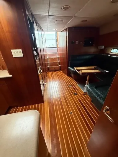 Shelly Anne Yacht Photos Pics Interior of 2000 Tiara Yachts 5200 Express with wood flooring and leather seating.