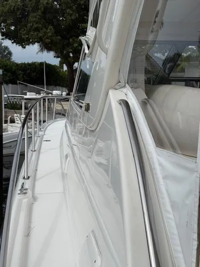 Shelly Anne Yacht Photos Pics Side view of a 2000 Tiara Yachts 5200 Express, showcasing sleek design and railing.